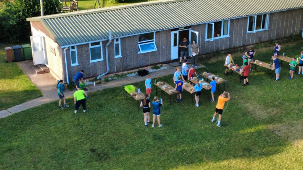 Scouts making bird houses and playing water games